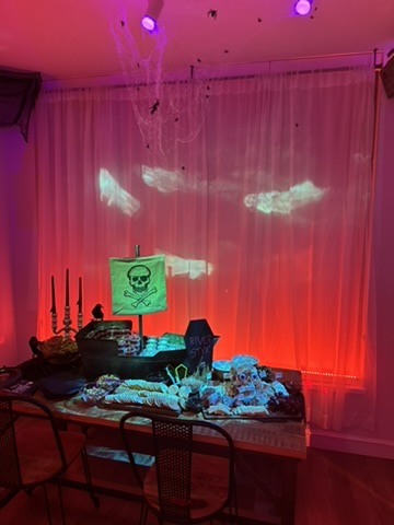 Ghostly projections across the curtains above the table.