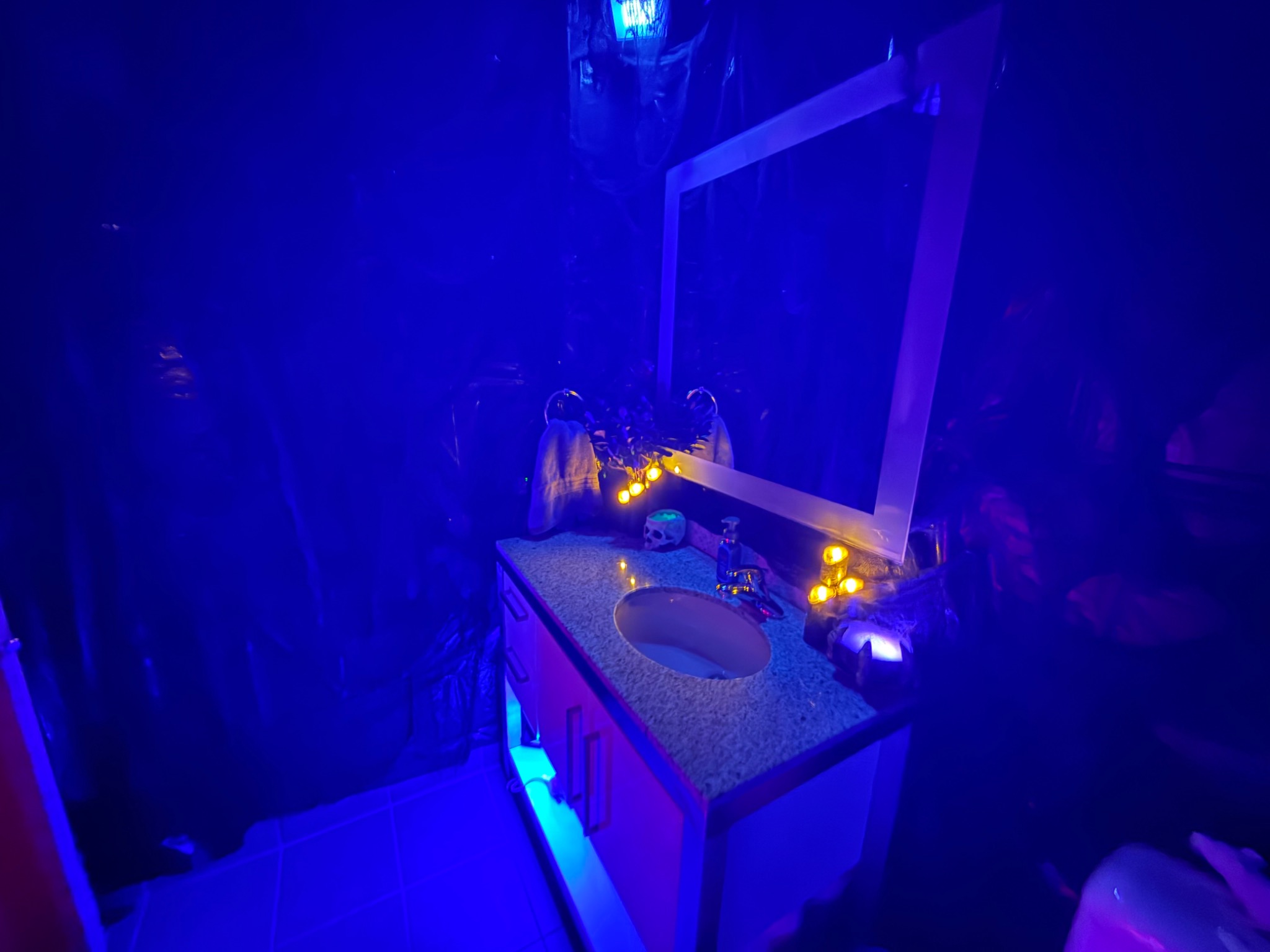 Candlelight and blue illumination in another corner of the party.