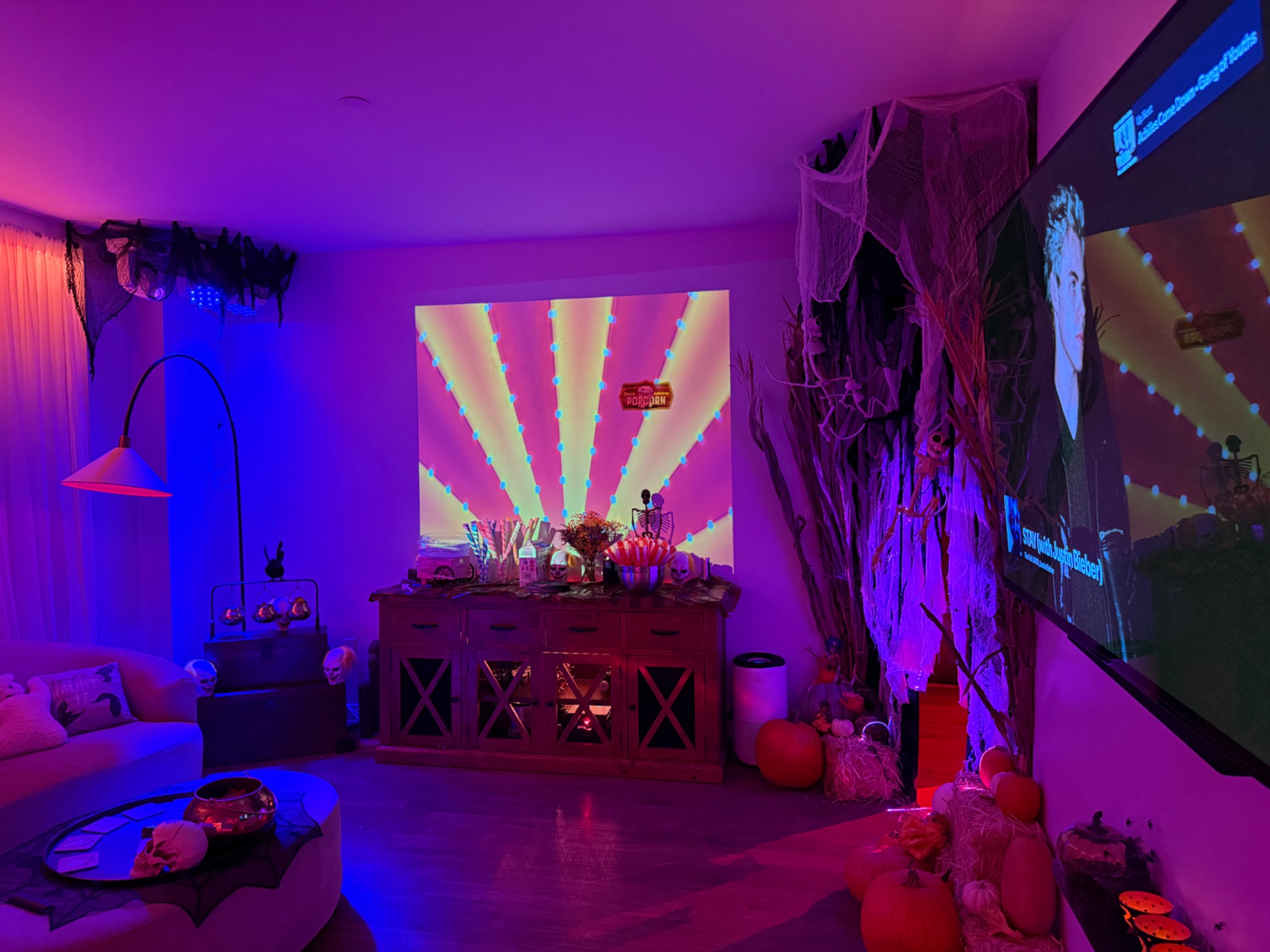 A striped circus projection above the decorated cabinet.
