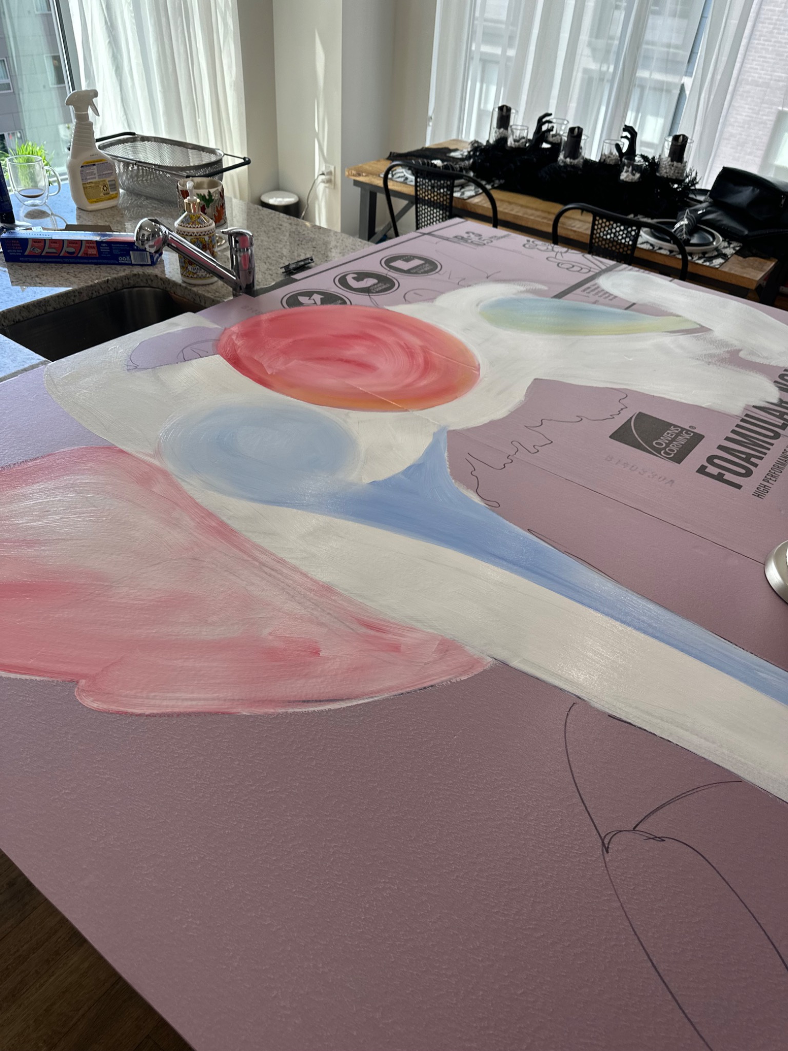 The oversized clown face begins on the worktable.