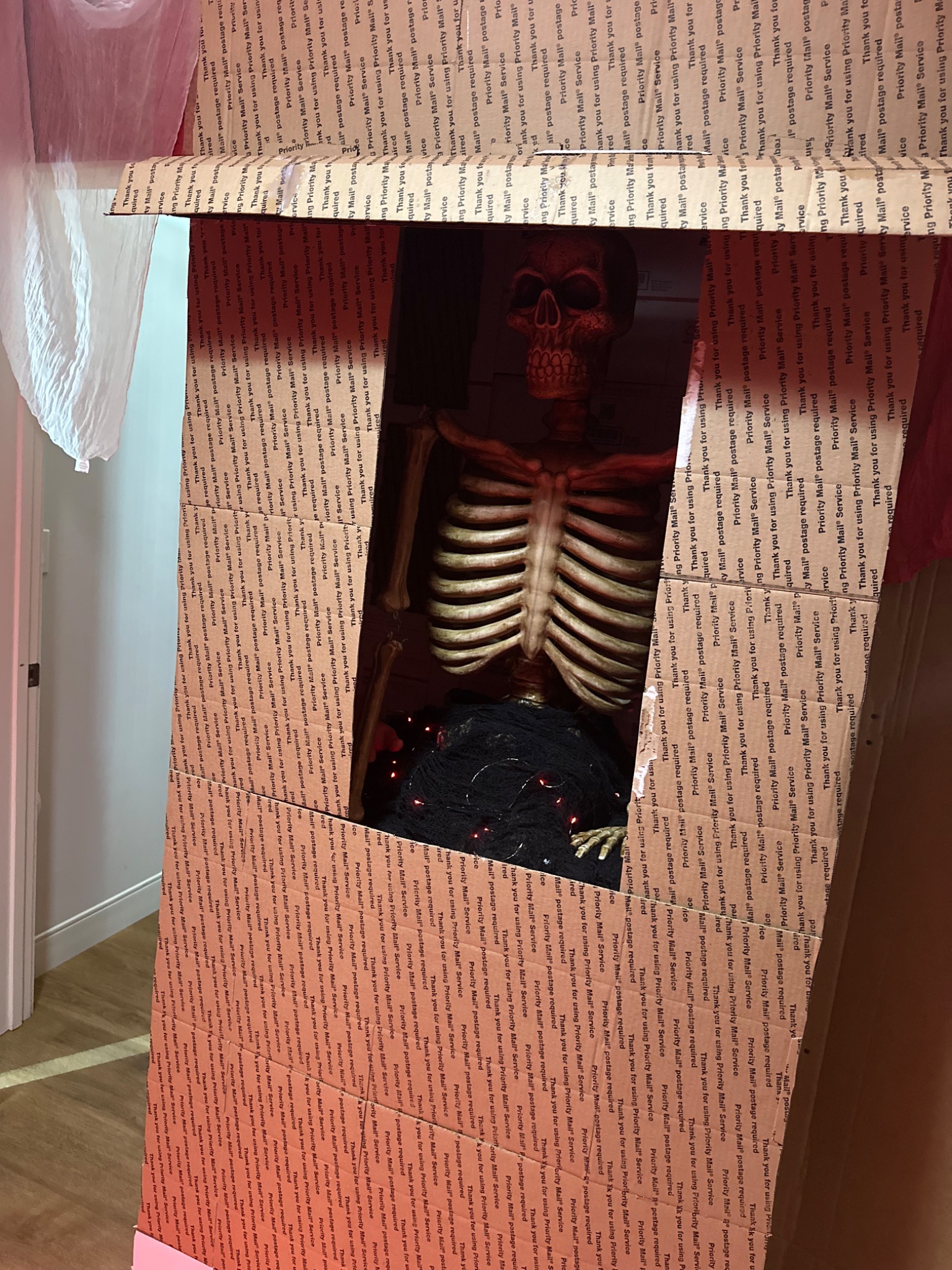 A skeletal fortune teller waits inside the booth during construction.