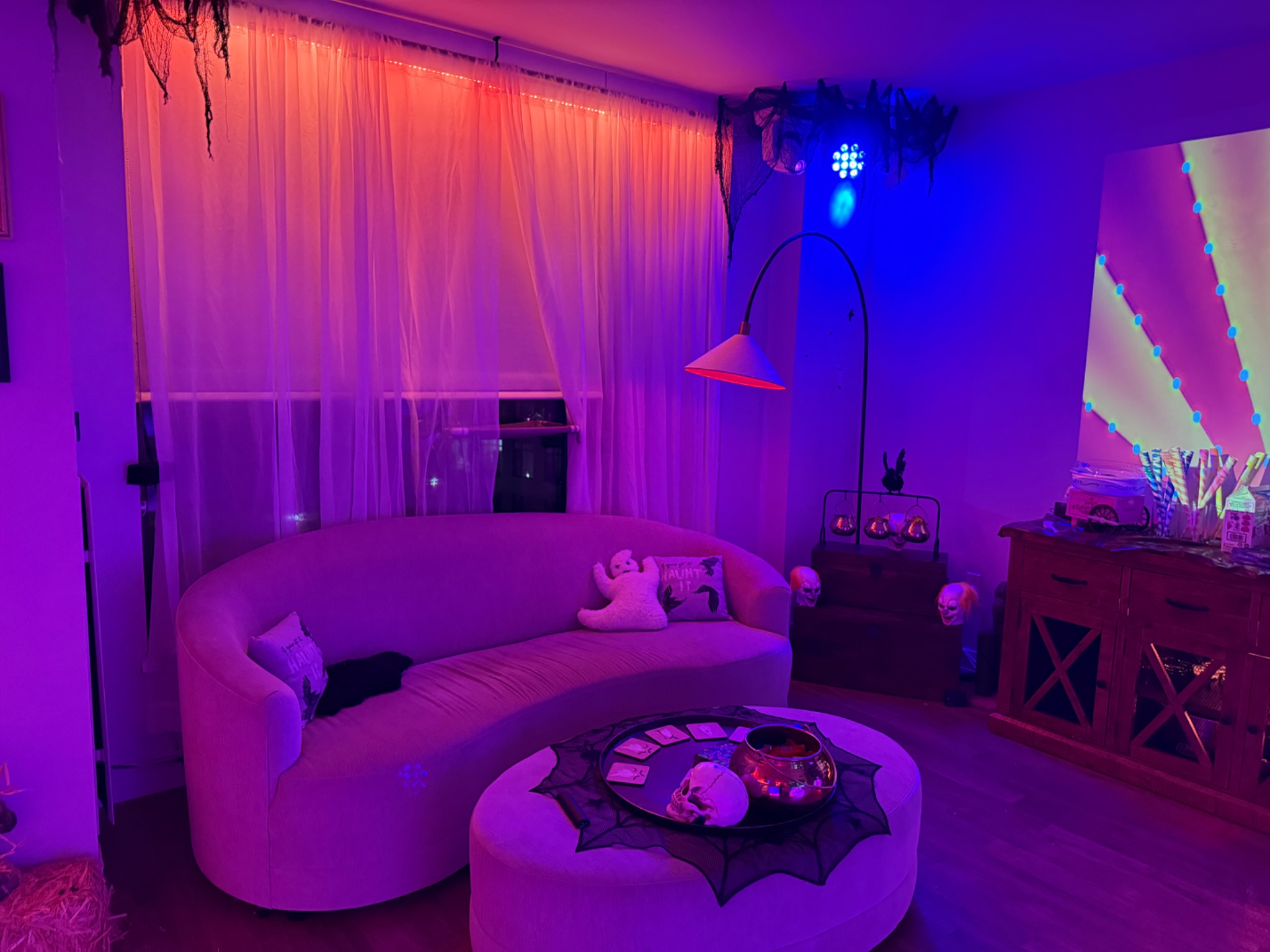 The lounge framed by curtains, projections, and blue light.