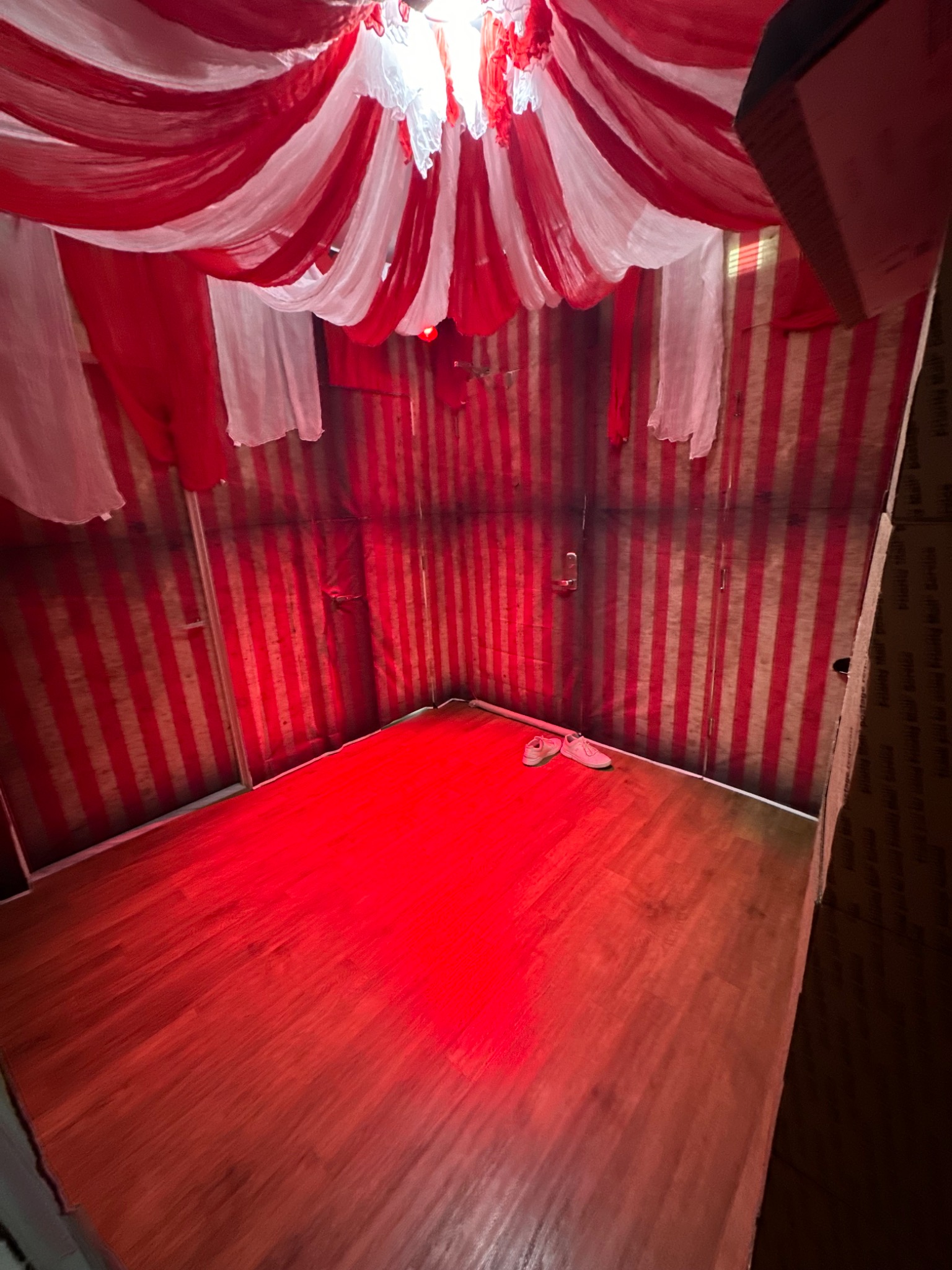 A red lighting test inside the striped room.