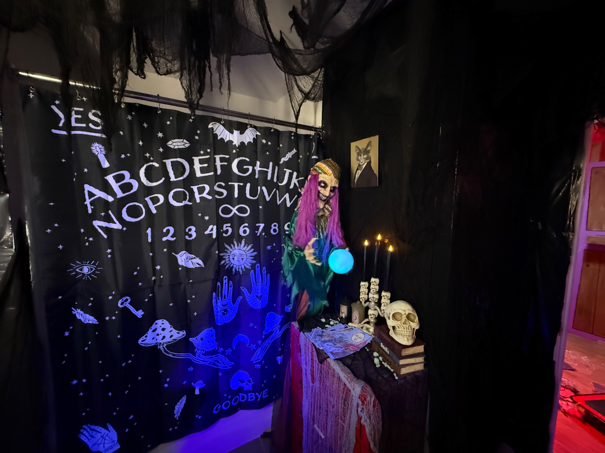 A spirit-board backdrop and fortune-telling display.
