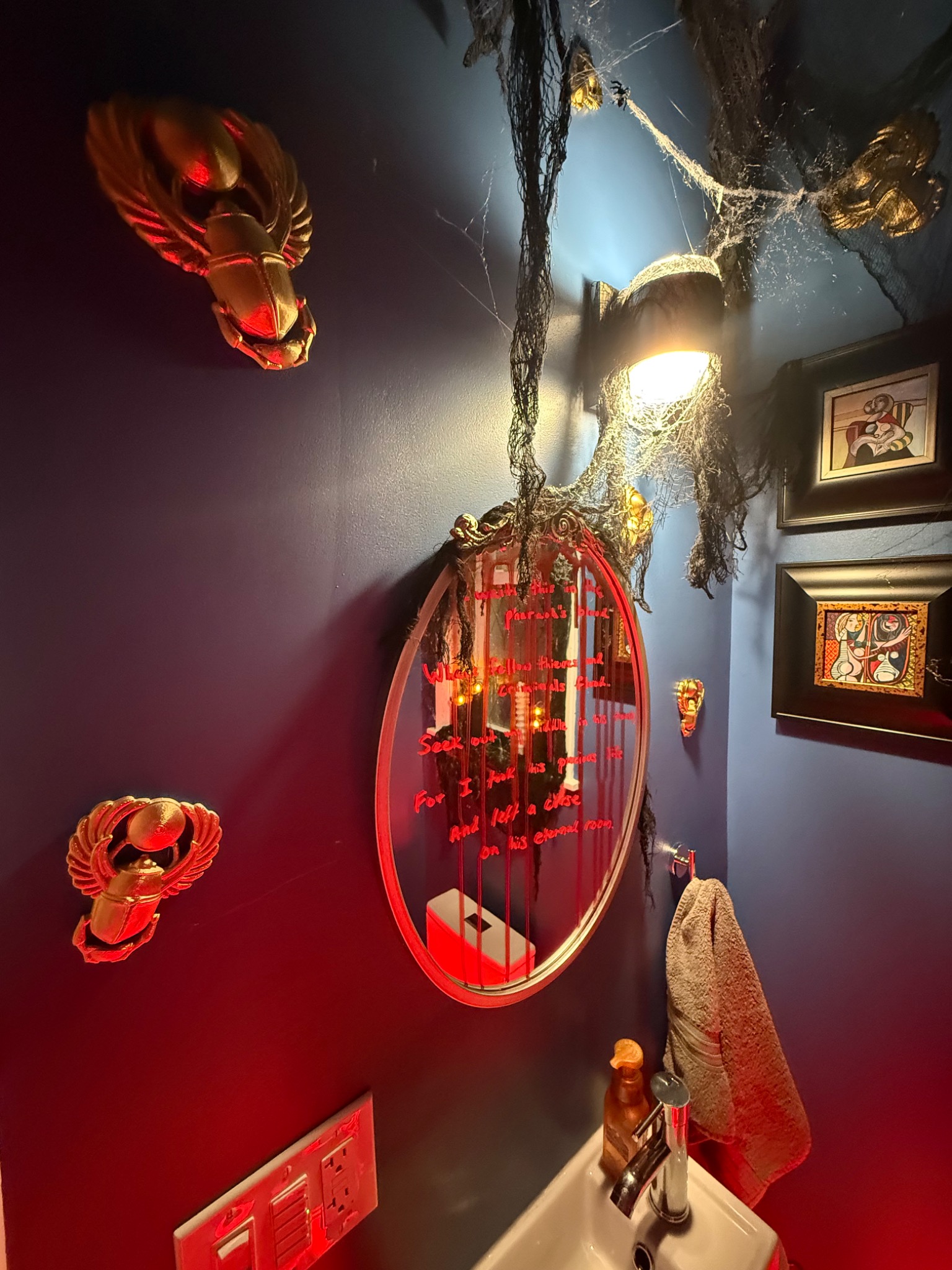 The mirror clue surrounded by scarabs and hanging gauze.