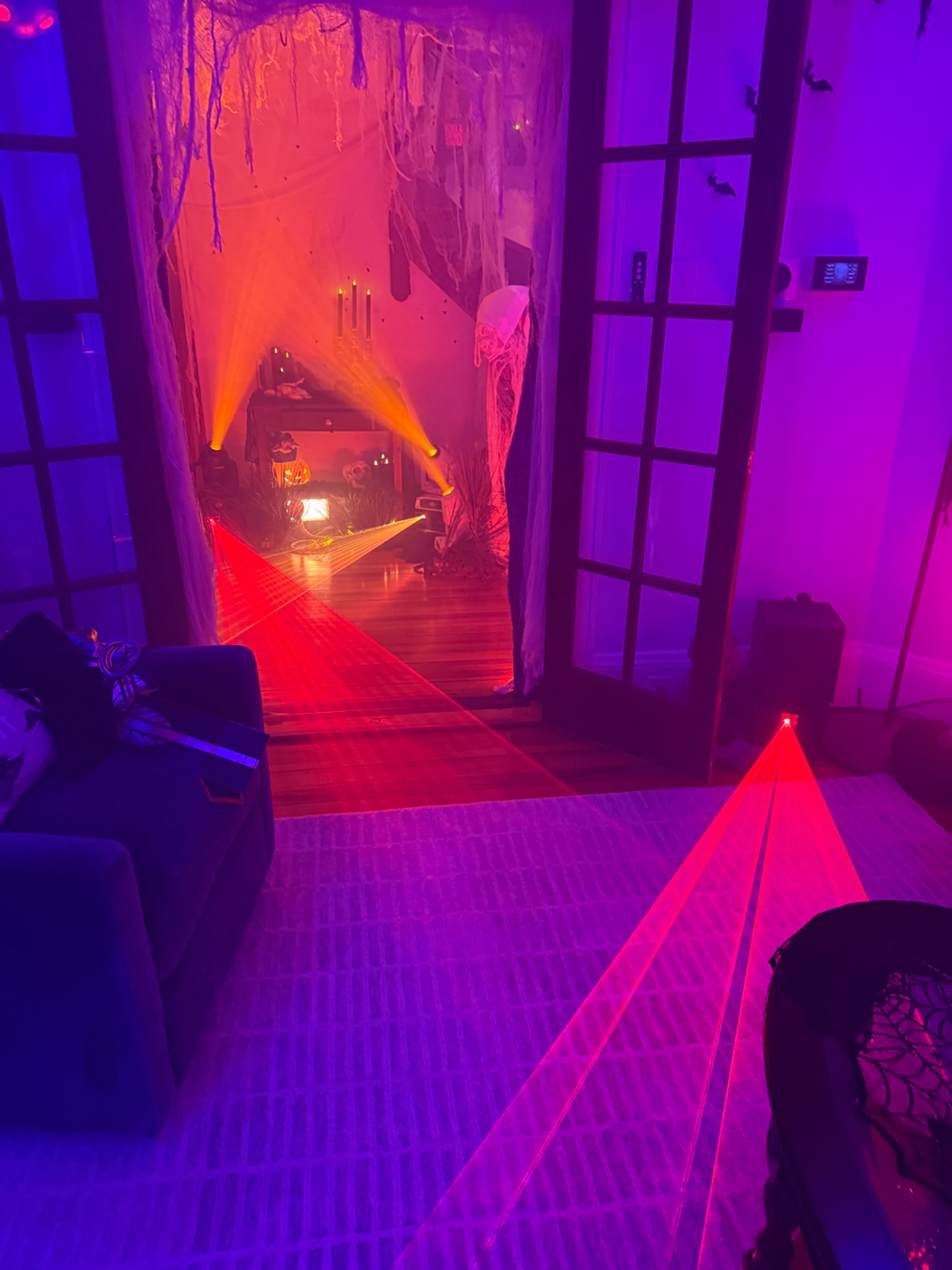 Laser beams crossing the doorway between the rooms.