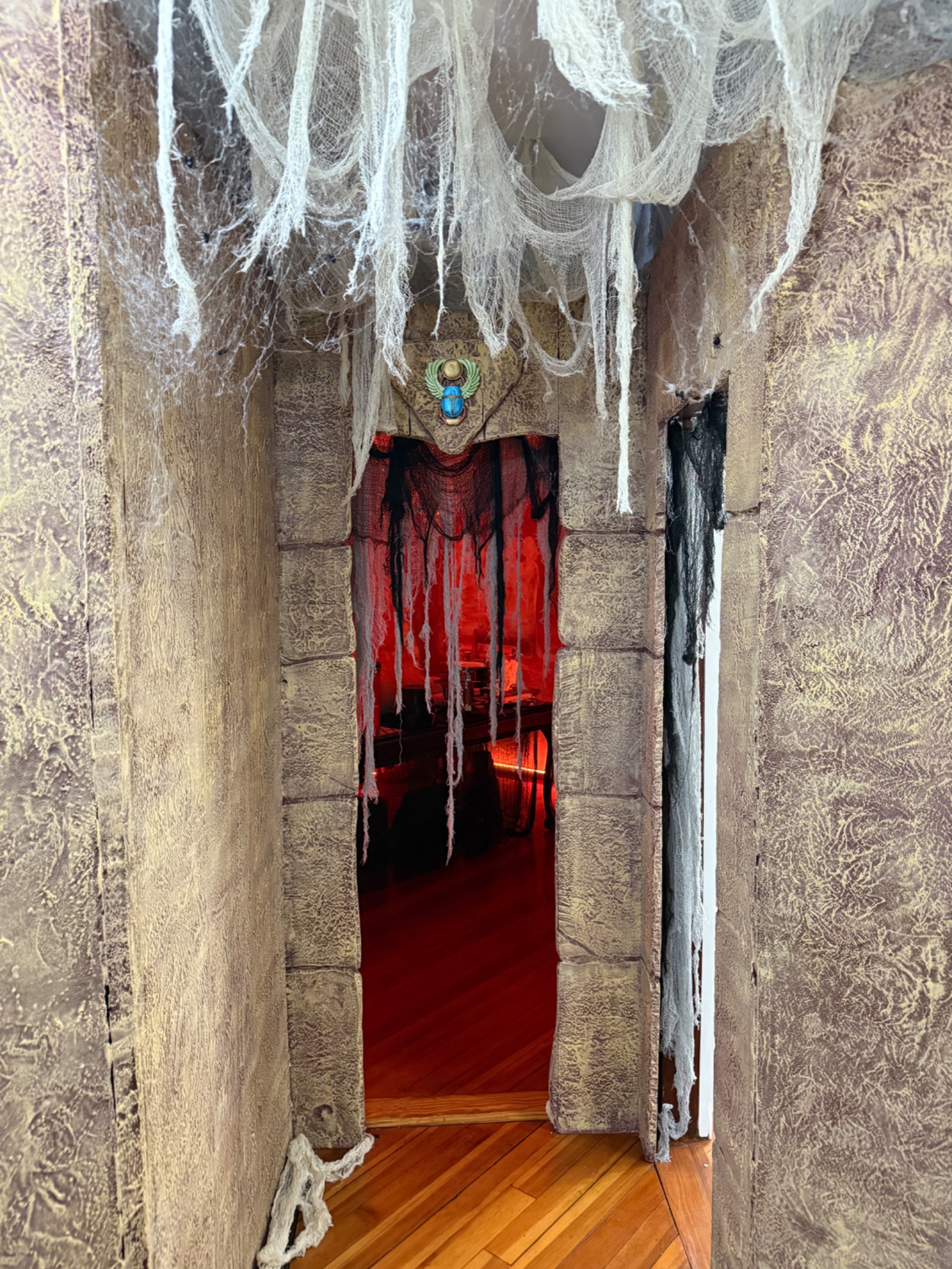 The tomb entrance in daylight, with the scarab above the doorway.