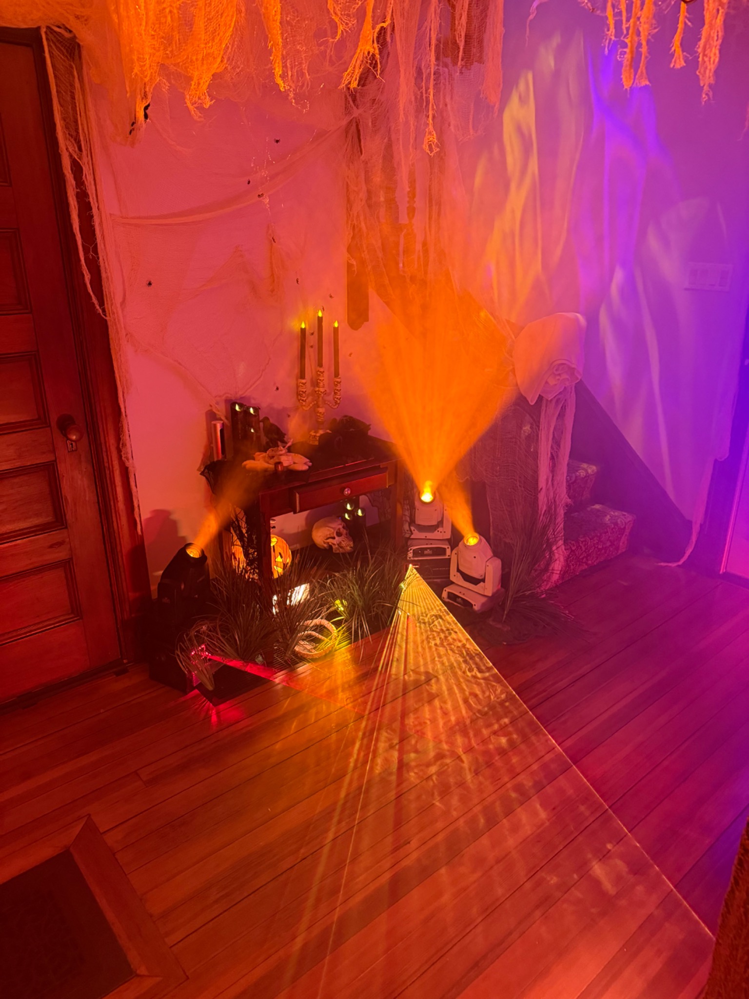 Amber and red beams through the tomb’s hanging gauze.